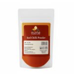 Red chilli powder in a bowl with vibrant red color, used as a spice for cooking.
